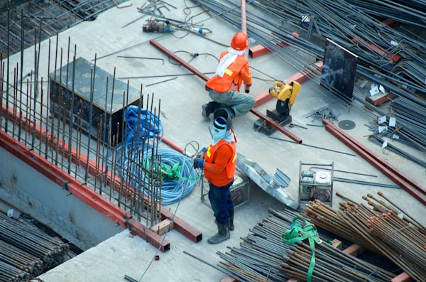 Construction crew with hardhats working together on a high-rise structure