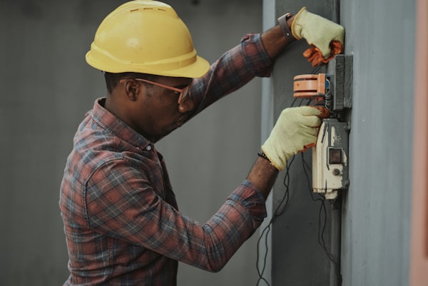 MEP technician sanitizing and cleaning AC air filters on home wall unit
